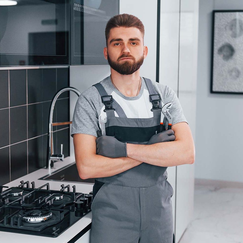 young-professional-plumber-in-grey-uniform-standin-resize.jpg